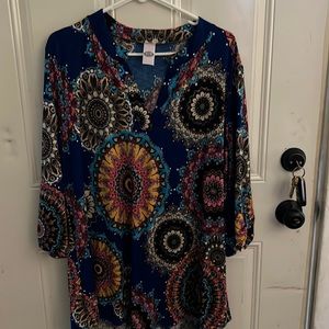 Multi color shirt looks great with white pants